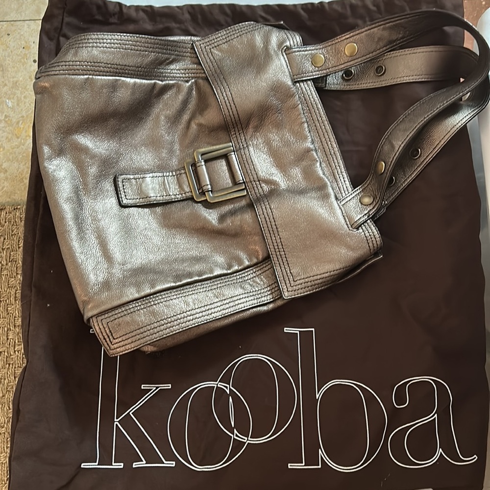 Kooba shoulder bag. Snaps on side for more volume. Comes with dust bag.